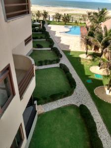 an aerial view of a resort with a pool and grass at Apartamento à beira-mar. Beachfront apartment in São Gonçalo do Amarante