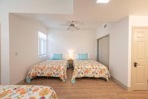 a bedroom with two beds and a ceiling fan at Class & Space Uptown in Charlotte