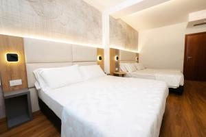 Postel nebo postele na pokoji v ubytování Hotel Everest
