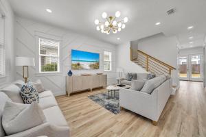 a living room with white furniture and a chandelier at Pinkie Preferred Property Private Heated Pool Emerald Escape in Destin