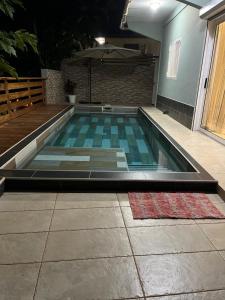 a swimming pool in the middle of a house at Le Lointain in Mtsamboro