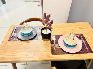 吉隆坡的住宿－Mercu Summer Suites KLCC By Sweet Home，一张木桌,上面有两盘盘,上面有植物