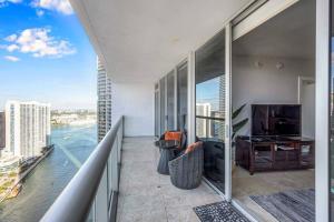 a room with a balcony with a view of the water at Icon 39th Floor 1 Bedroom apartment- Bay & City View- FREE SPA in Miami