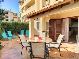 a patio with a table and chairs on a patio at 3 bed ground first floor apartment. Close to beach in Mar de Cristal