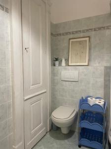 a bathroom with a toilet and a white door at Appartamento centro storico in Via Palestro in Ivrea