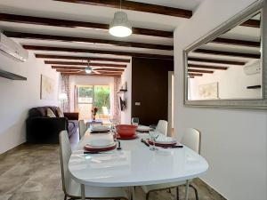 a dining room with a white table and chairs at 3 bed ground first floor apartment. Close to beach in Mar de Cristal