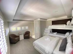 a bedroom with a bed and a desk and a chair at Grospe Resort Boracay in Boracay