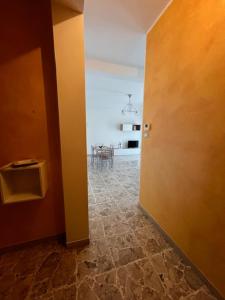 a hallway with a room with a table and a door at Il Momento in Lanciano