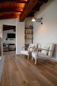 a living room with white furniture and wooden ceilings at Agriturismo La Costa in Gropparello +64 photos
