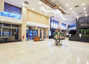 a lobby of a building with a table with flowers on it at Dedeman Istanbul in Istanbul