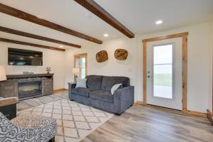 a living room with a couch and a fireplace at Charming Biglerville Home with Patio and Yard! 
