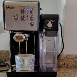 a coffee maker with a cup on a counter at Apart. con aire, frente al mar in Porlamar
