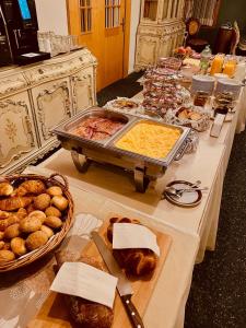 ein langer Tisch mit einem Buffet mit Speisen und Brot in der Unterkunft Historisches Hotel Bären in Kiental