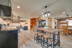 a kitchen with a large island with bar stools at Charming Biglerville Home with Patio and Yard! 