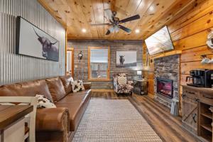 a living room with a couch and a fireplace at Rustic Mountain Retreat by Ghosal Luxury Lodging in Pigeon Forge