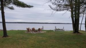 a picnic table and bench next to a lake at Lilly Pay11 in Crivitz