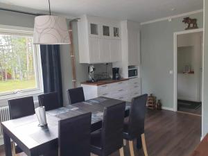 a kitchen and dining room with a table and chairs at Bergsgatan 5 Arjeplog in Arjeplog