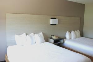 a hotel room with two beds and a phone at Van Buren Inn in Van Buren