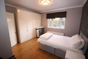 a small bedroom with a bed and a window at Harrow On The Hill Place in London