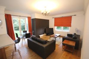 a living room with a couch and a table at Harrow On The Hill Place in London