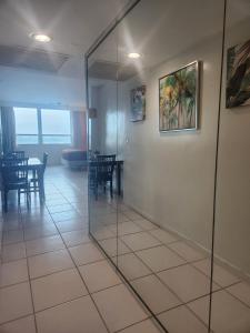 a glass wall in a room with a table and chairs at L&D Vacations Rentals in Miami Beach