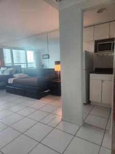 a large bedroom with a bed and a kitchen at L&D Vacations Rentals in Miami Beach