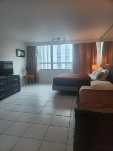 a hotel room with two beds and a television at L&D Vacations Rentals in Miami Beach