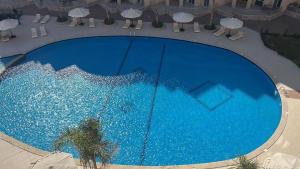 an overhead view of a large blue swimming pool at Princess Resort in Hurghada