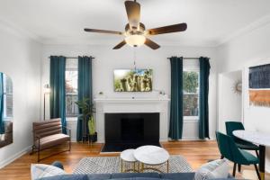 a living room with a ceiling fan and a fireplace at Luxe Modern Apartment in the Heart of Phoenix (1) in Phoenix