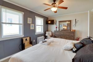 a bedroom with a bed and a ceiling fan at Oceanfront Milford Home with View and Boat Access in Milford