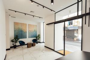 a room with two chairs and a glass door at RS Boutique Apartments in Alicante