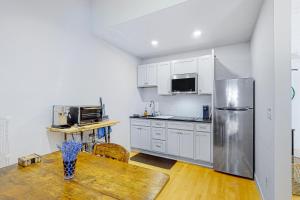 a kitchen with a wooden table and a refrigerator at Harborwalk Studio in Camden