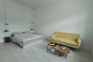 a bedroom with a bed and a couch and a table at Apartment Gdynia Centrum SEA 5 min do morza in Gdynia