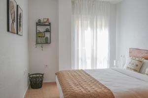 a bedroom with a bed and a large window at Apartamento Las Brisas, Atico in Puerto de Mazarrón