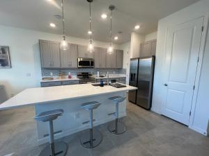a kitchen with a large island with bar stools at Davenport 1 in Davenport