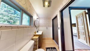 a small bathroom with a sink and a mirror at The Stone Mason - Large Modern Home on 5 Acres - 2 Hrs from NYC in Pond Eddy +35 photos