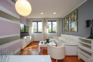 a living room with a white couch and a table at NEW Luxury apt in Plaza de España - FREE parking in Seville