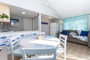 a kitchen and living room with a table and chairs at Hampton Beach Seaside Villa Unit 2 in Hampton