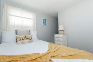 a bedroom with a bed with a pillow and a window at Hampton Beach Seaside Villa Unit 2 in Hampton