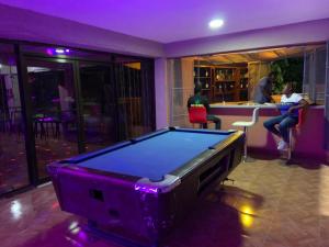 a pool table in a room with a bar at Lakou Breda in Cap-Haïtien