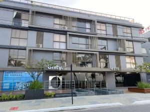 a building with a sign on the front of it at Beautiful Accommodation - #Unity Flats Cabo Branco in João Pessoa +63 photos