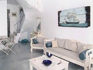 a living room with a couch and a table at Dolce Vita Waterfront Villa, Logaras, Paros in Kampos Paros