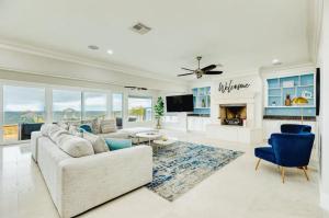 a living room with a couch and a fireplace at Kemah Bayfront Luxury Resort Getaway with Pool in Kemah