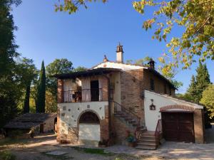 an old house with a staircase and a balcony at Il Bosco del Lebbio in Montaione +31 photos