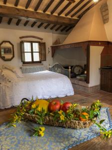 a bedroom with a bed and a tray of fruit at Il Bosco del Lebbio in Montaione