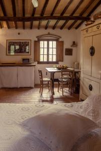 a kitchen and dining room with a table and chairs at Il Bosco del Lebbio in Montaione