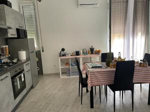 a kitchen with a table and chairs in a kitchen at ANGEL ROOM in Cagliari