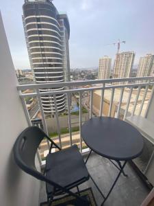 a table and chair on a balcony with a view of a city at Cozy and Convenient studio unit @ Inspiria condominium in Davao City