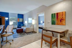 a hotel room with a living room with a living room at Home2 Suites Dallas-Frisco in Frisco