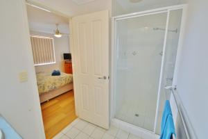 a bathroom with a walk in shower next to a bedroom at Surfside Retreat - Kalbarri WA in Kalbarri